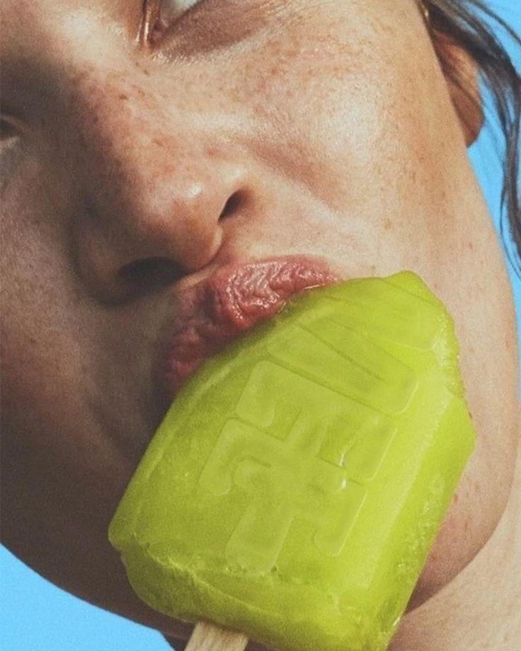 Close-up of a smile beside a lime-green object