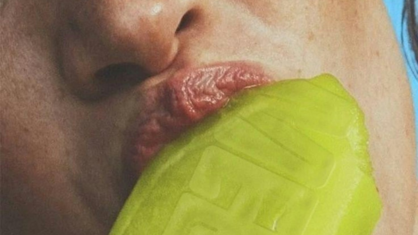 Close-up of a smile beside a lime-green object