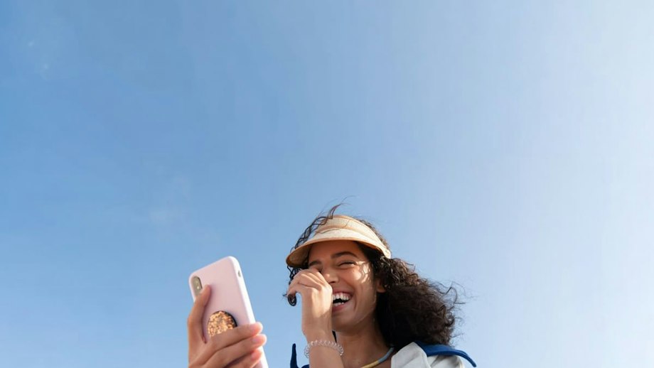 A man on the phone under a blue sky