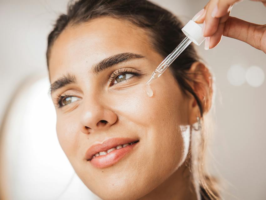 Woman putting skincare on