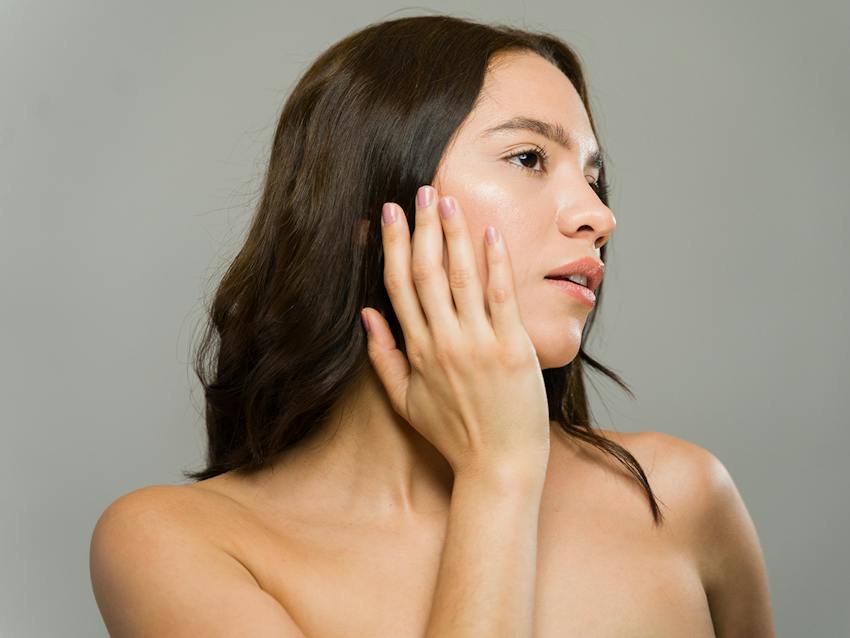 Woman touching her face