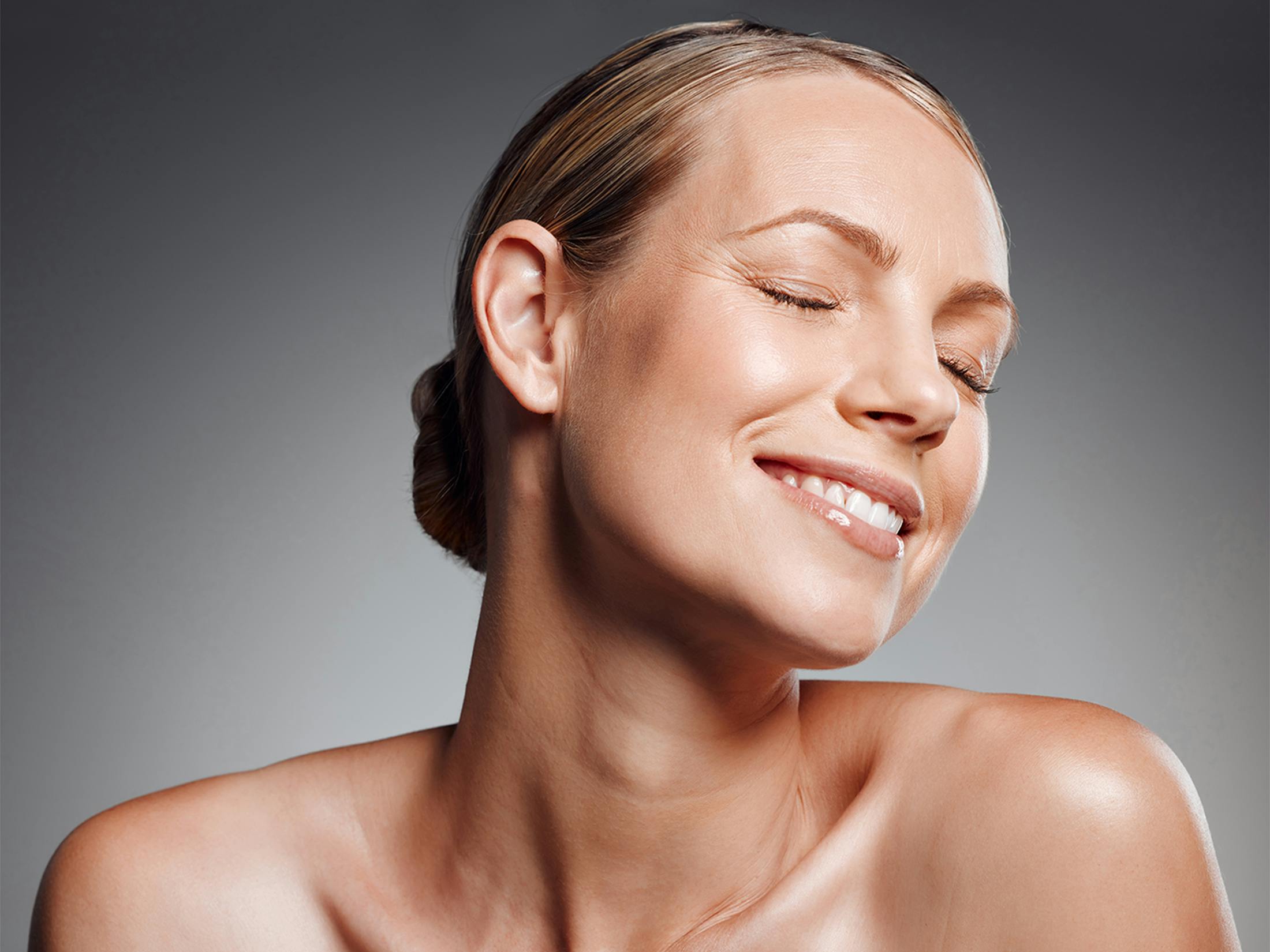 Woman smiling with her eyes closed