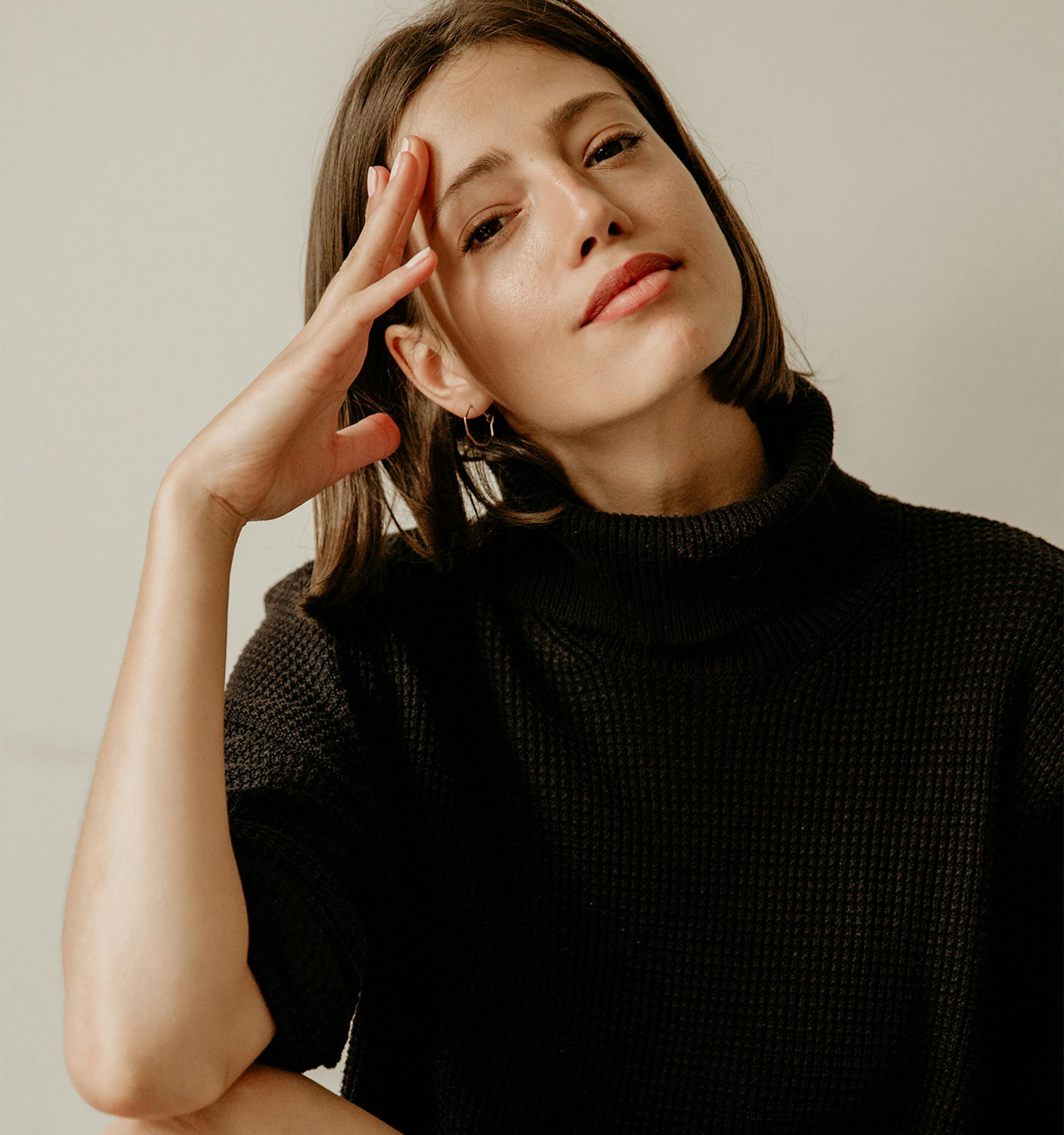 woman touching her head