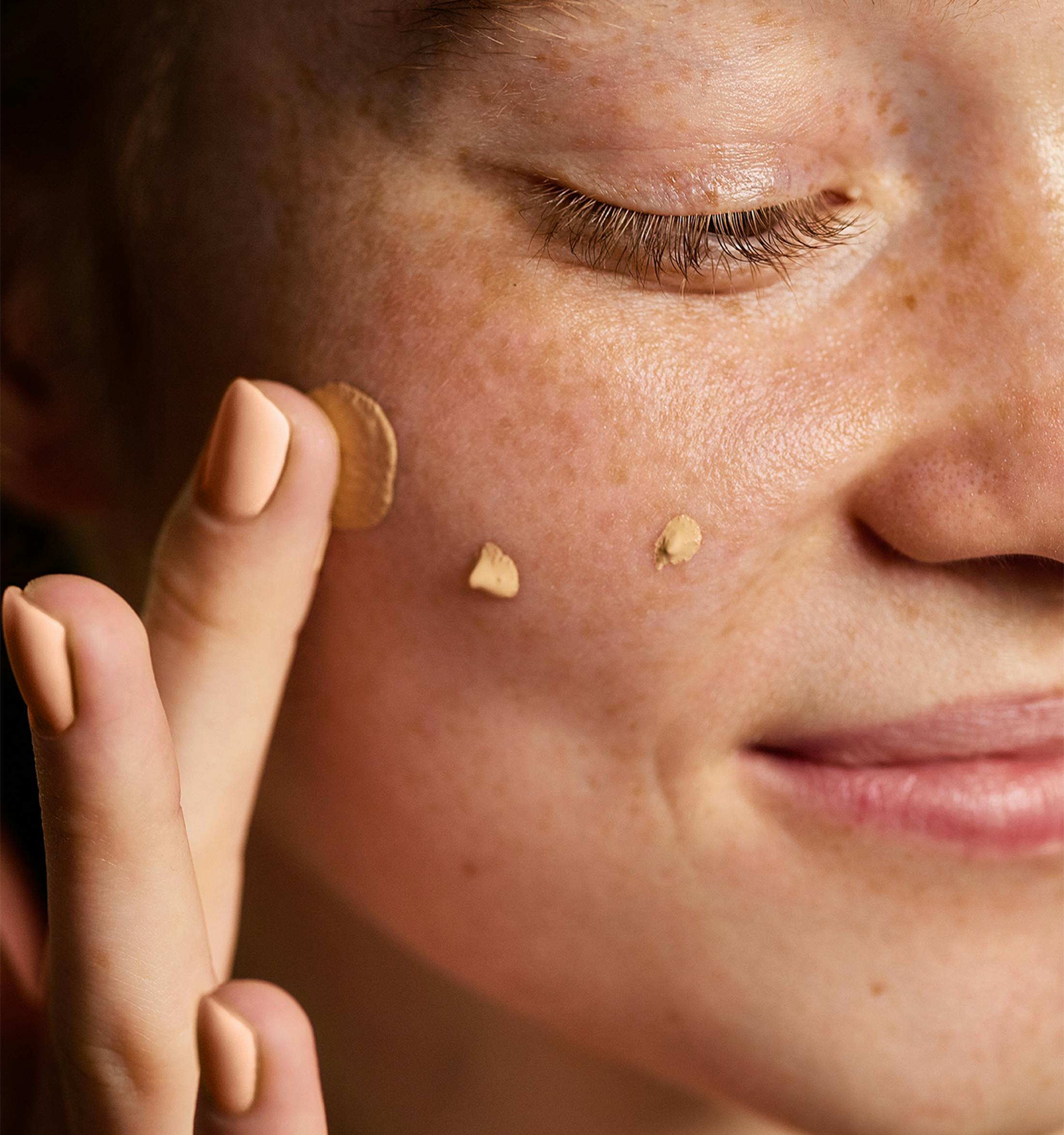 Woman putting skincare on