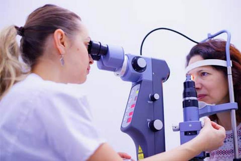 patient and optometrist testing eyes