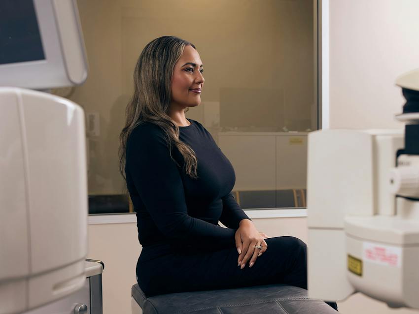 woman sitting in an eye exam room