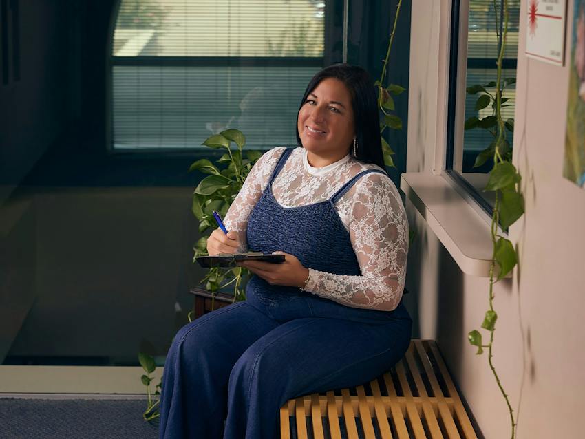 Woman smiling filling out forms