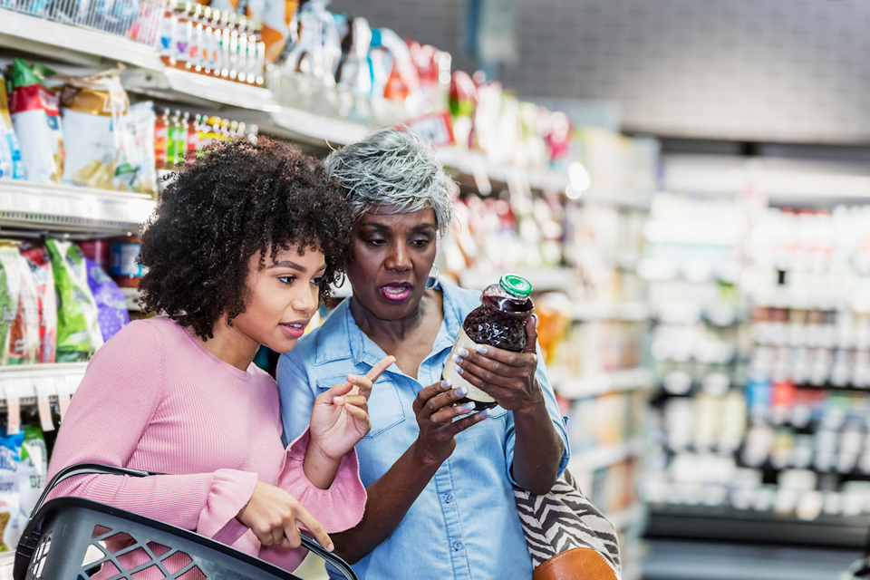 Two women at a supermaket checking the Nutrion facts of a product