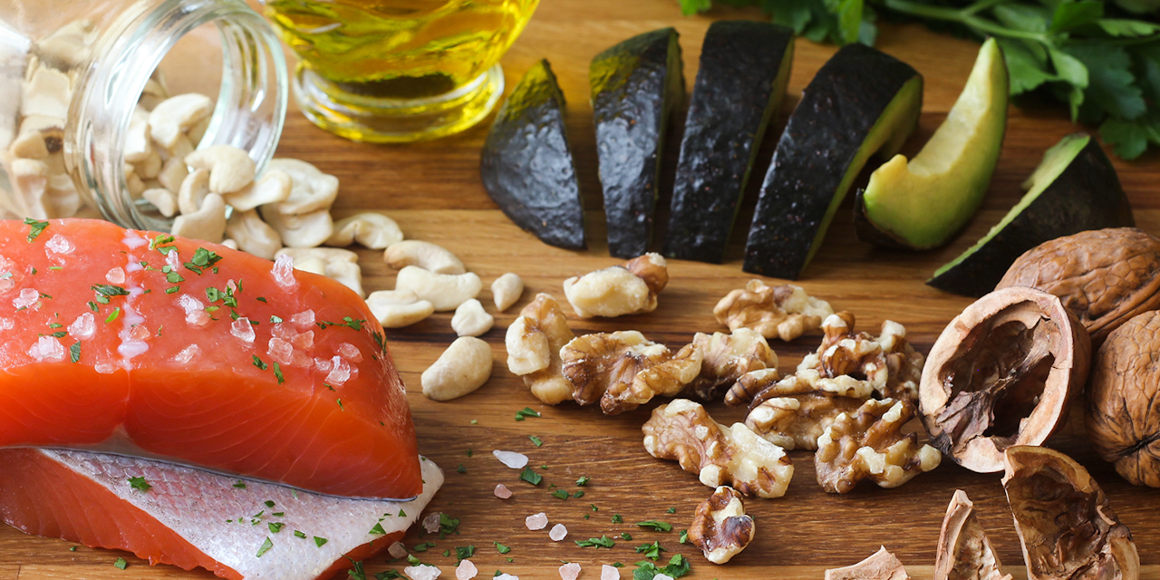 Table tob with Omega-3 rich foods such as walnuts, avocado and olive oil.