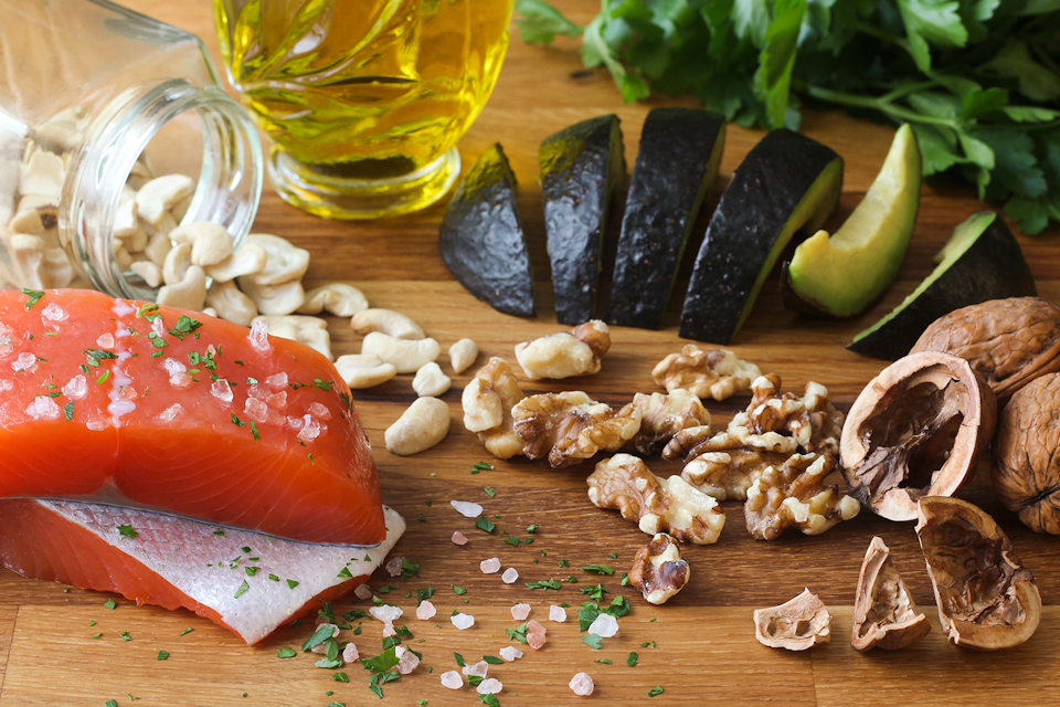 Table tob with Omega-3 rich foods such as walnuts, avocado and olive oil.