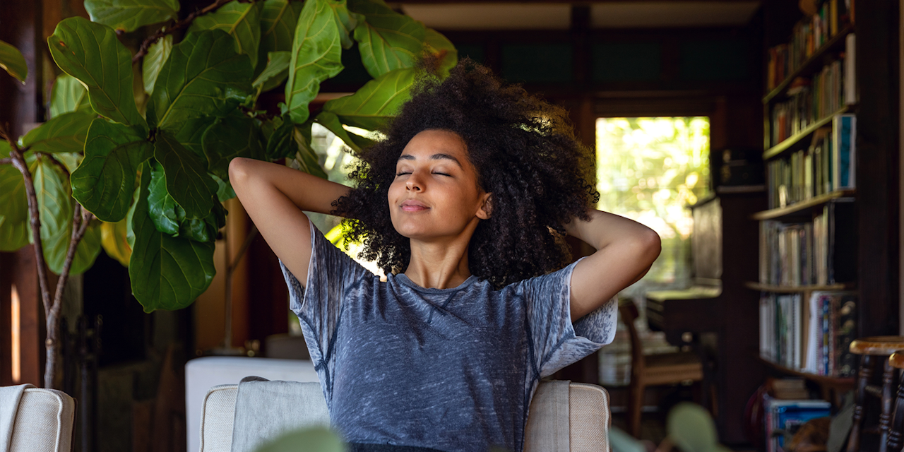 Woman relaxing Woman sits back and relaxes on her living room.
