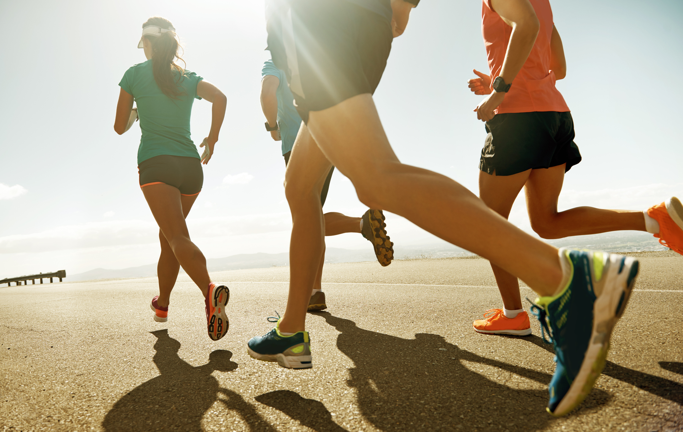 Group of people running along a road 