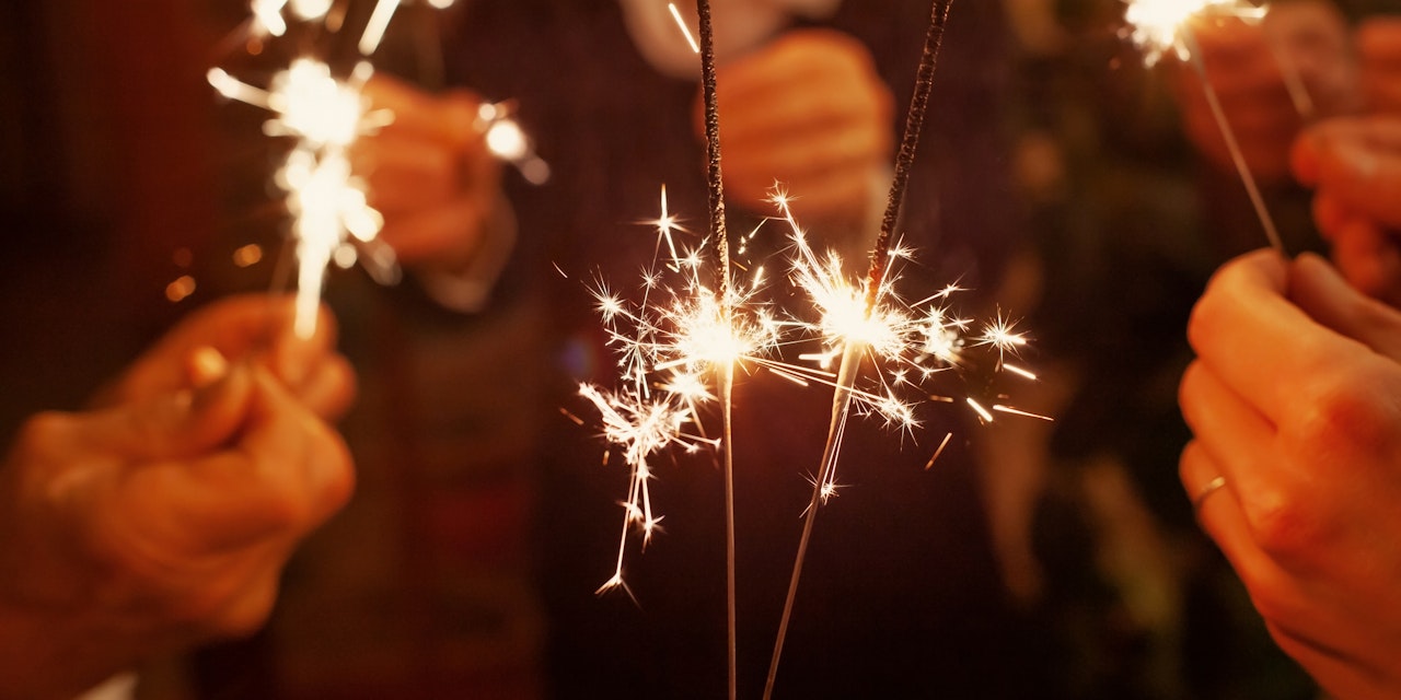 People holding sparklers at a new year's party