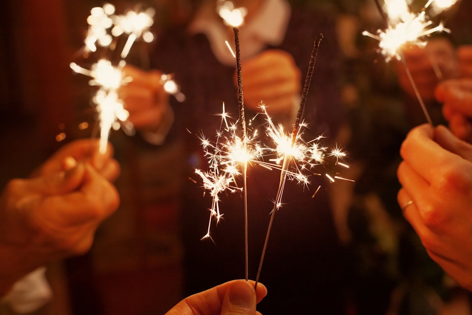 People holding sparklers at a new year's party