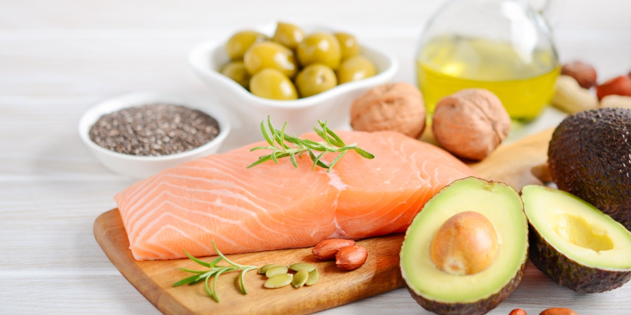 Selection of healthy fats, such as fish, avocado, olives, nuts and seeds, selective focus.
