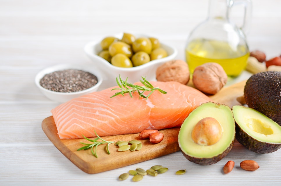 Selection of healthy fats, such as fish, avocado, olives, nuts and seeds, selective focus.