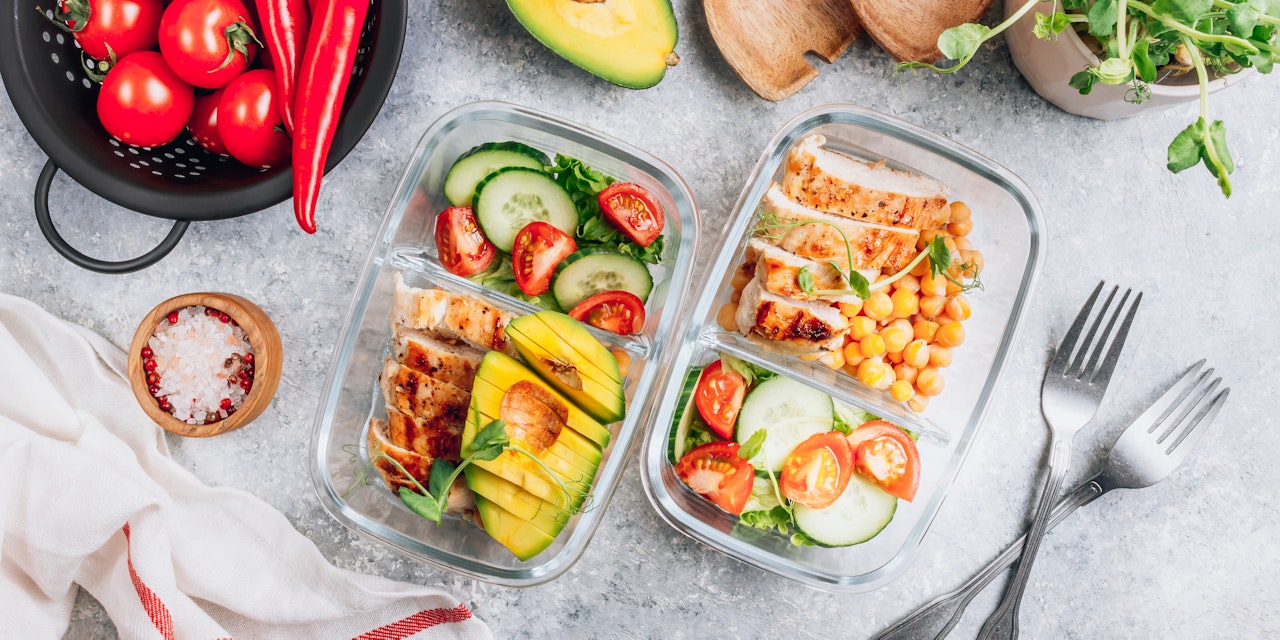 Healthy meal prep containers with chickpeas, chicken and salad