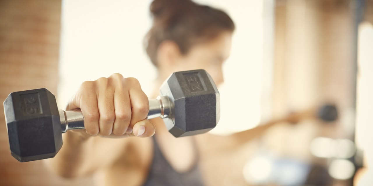 Woman lifting dumbbells in the gym
