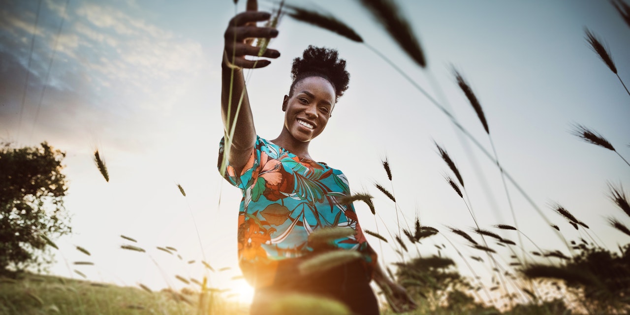 Woman in wheat field Whole grains are key to sustainability