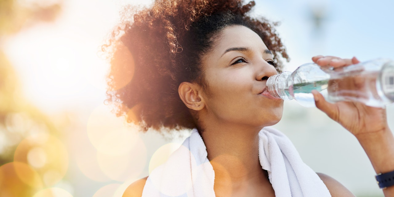 Water-Challenge-Header A young woman drinking water from a bottle