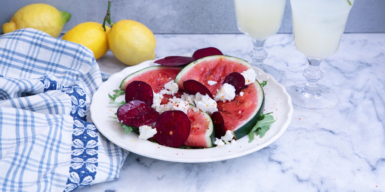 Grilled watermelon Grilled watermelon salad with beets, cheese, and drinks on the side
