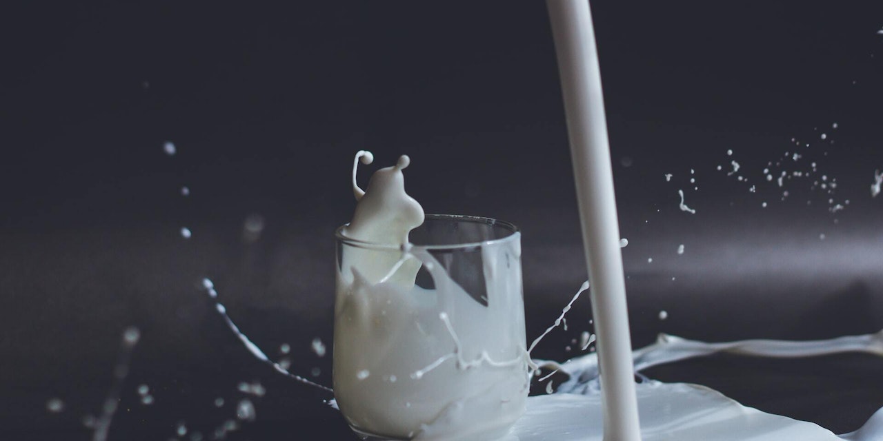 Got (plant-based) milk? A glass of milk being poured and spilled