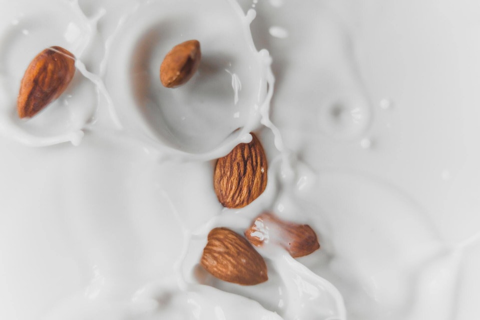 Almonds splashing into milk