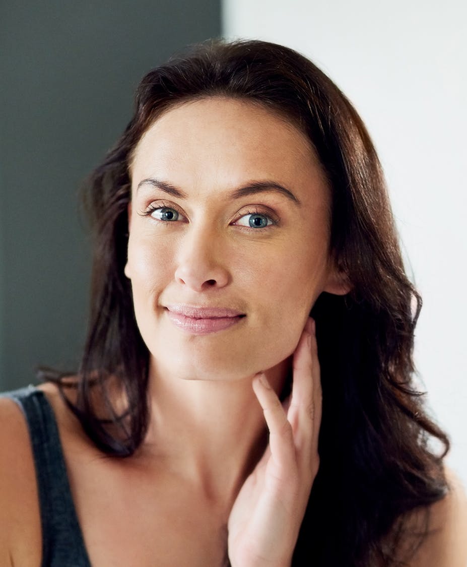 Woman smiling touching her jaw