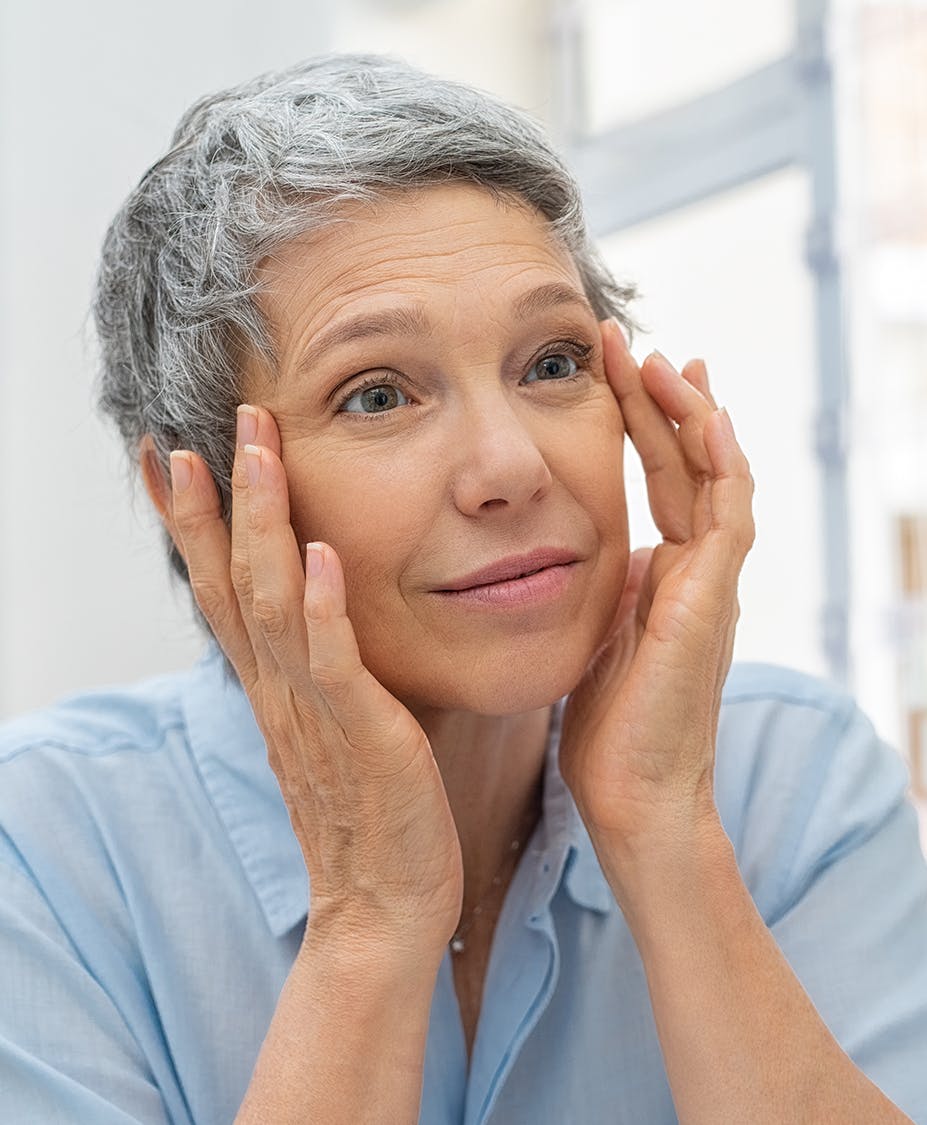 Older woman touching her temples