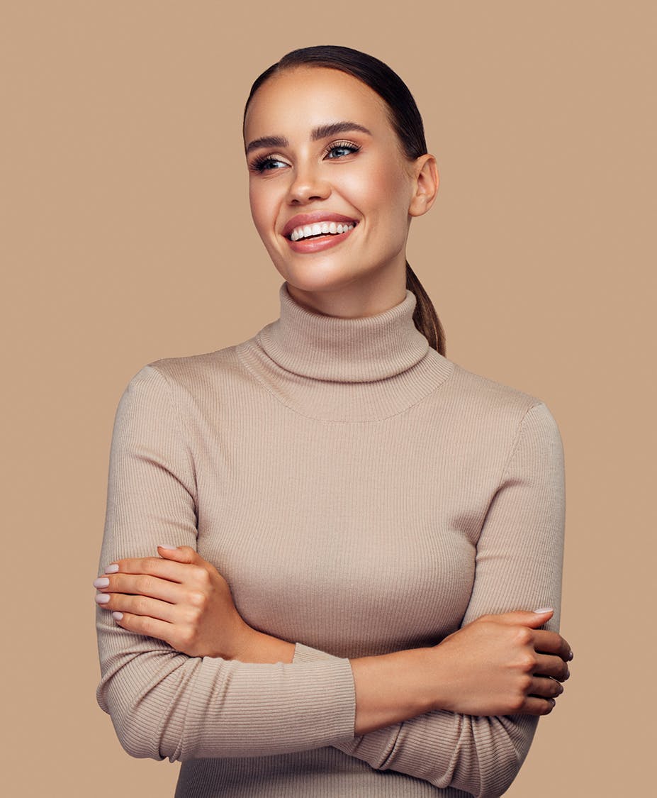 Young woman smiling with arms crossed
