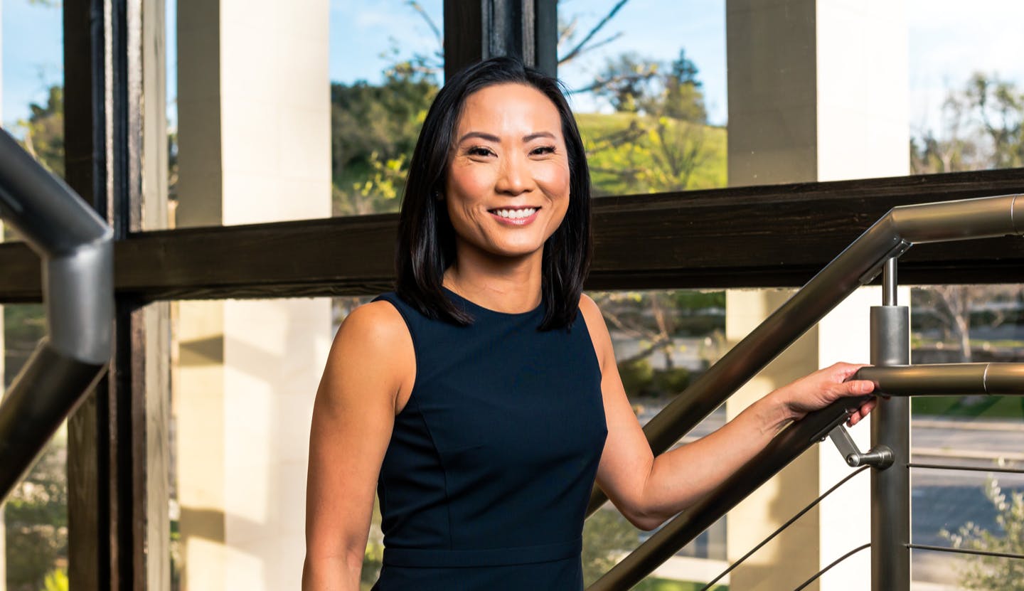 Dr. Tansavatdi in a black dress smiling