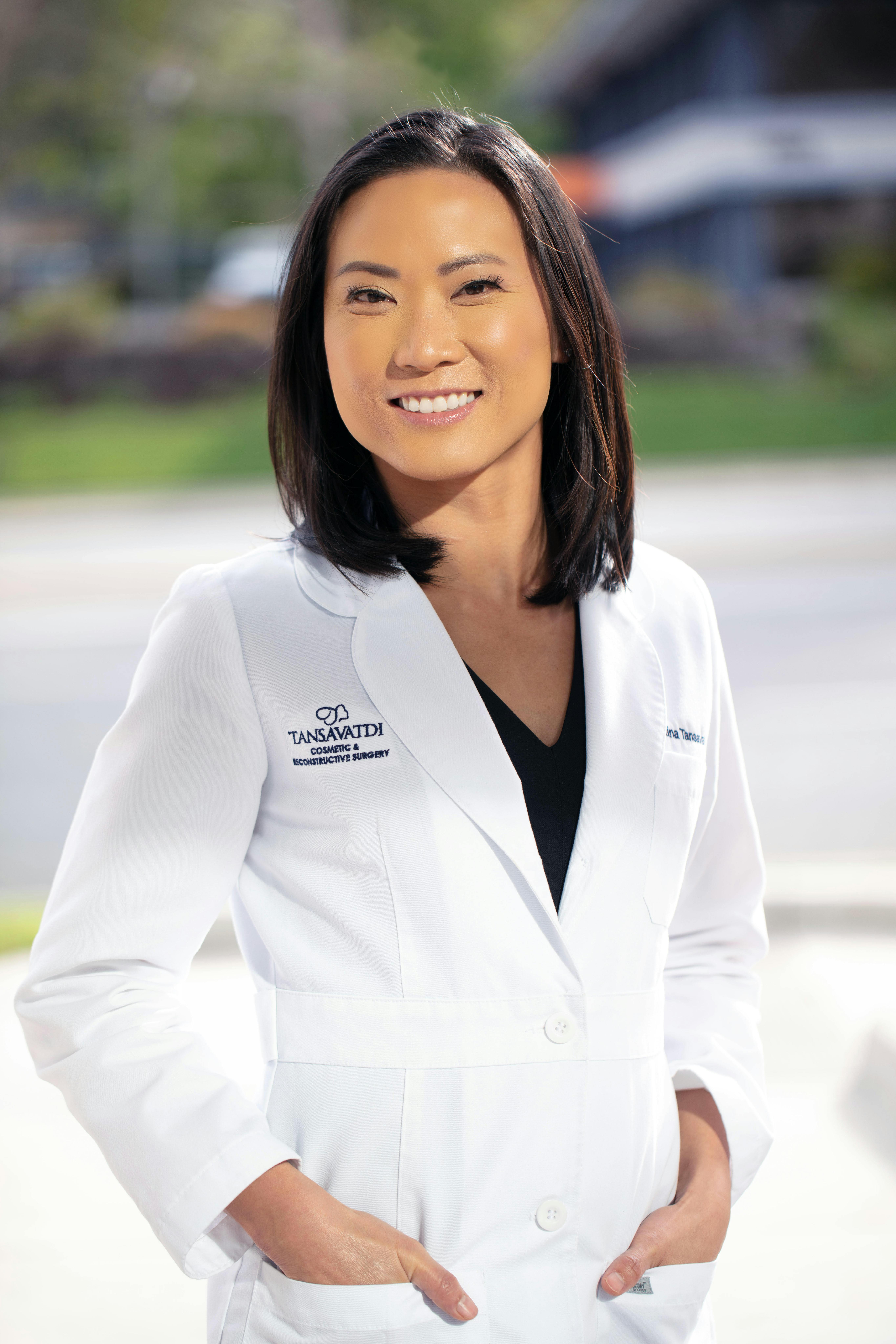 Dr. Tansavatdi in a lab coat smiling