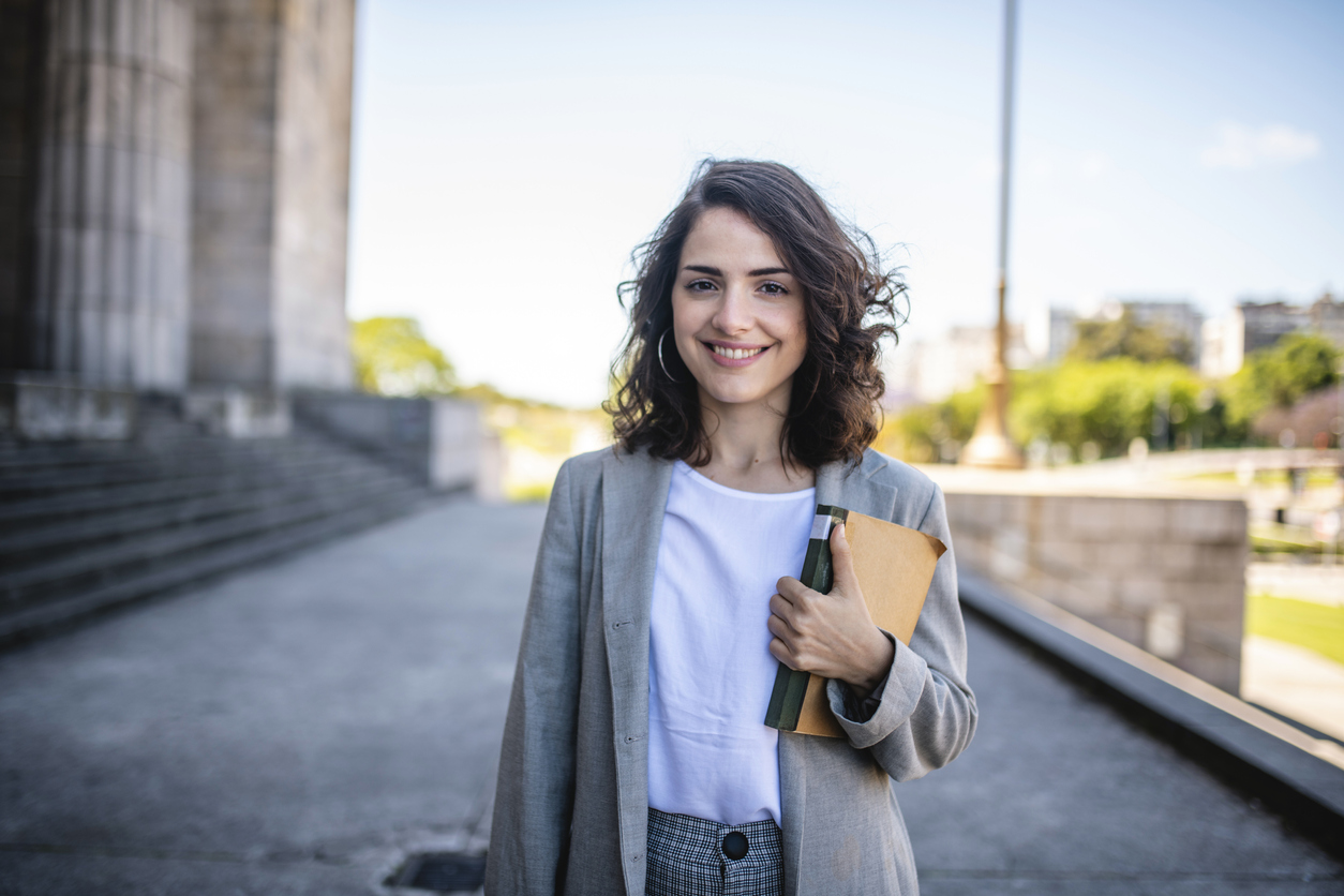 Girl holding a book and smiling