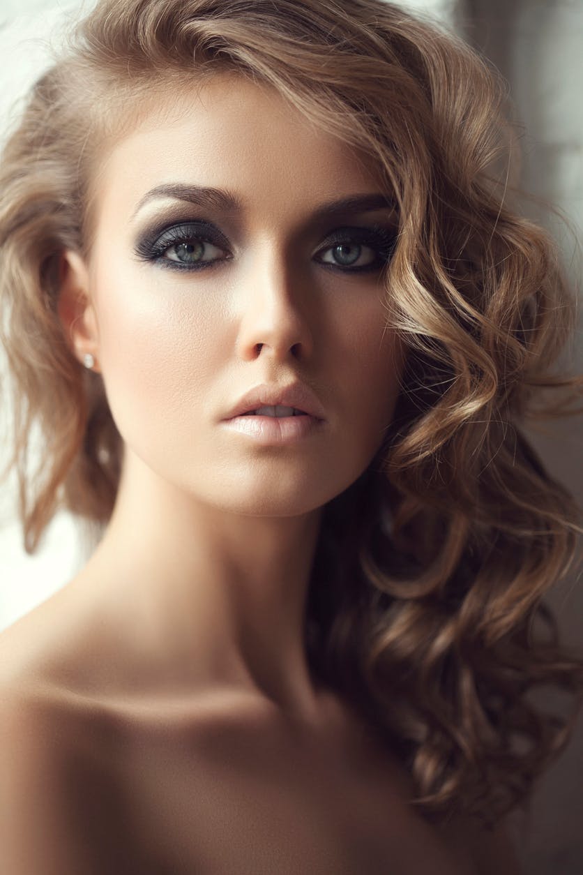 beautiful woman with dark eye makeup and a smooth skin