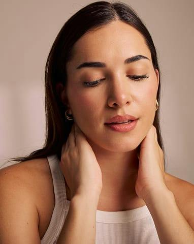 woman touching her neck