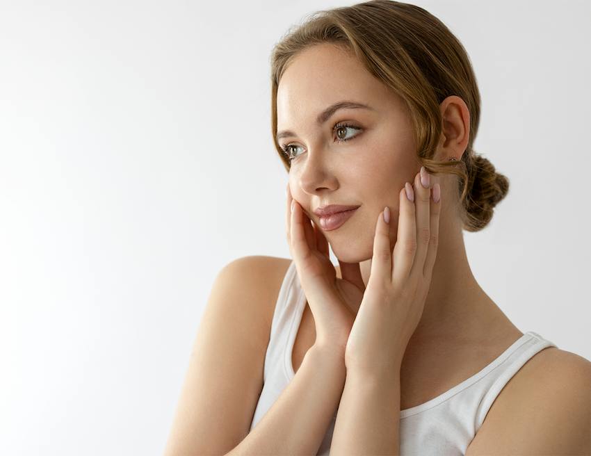 A woman touching her face