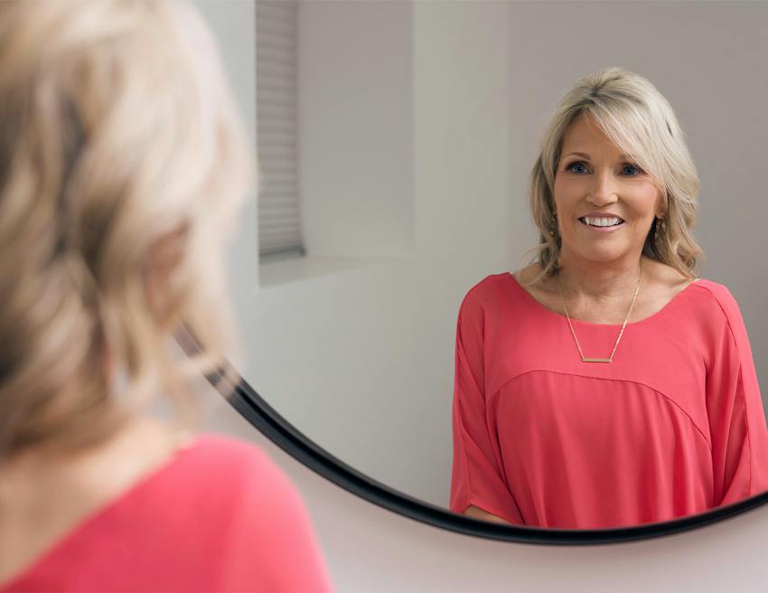 women staring into a mirror