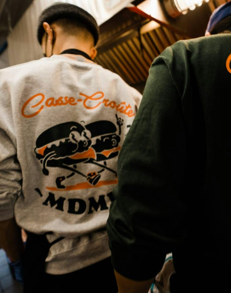 A staff member seen from behind wearing an MDMH crewneck