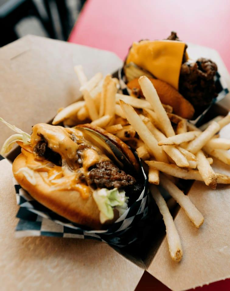 Burgers and fries served on checkered paper