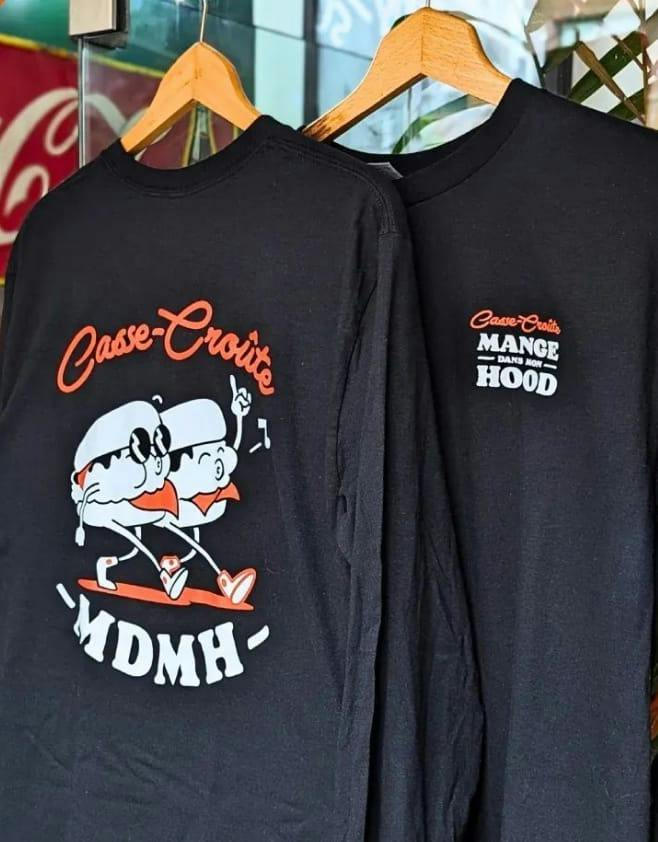 Black MDMH shirts on hangers