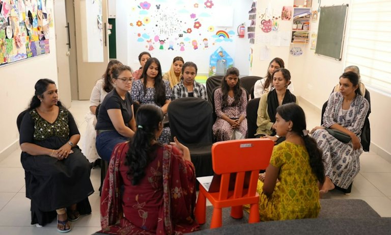 Parents and teachers seated in a circle for an ULTRA Conversations session at ULTRA School