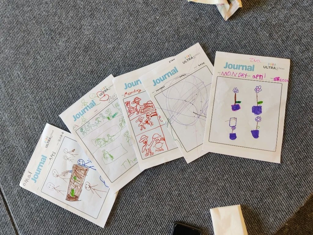 Children's learning journals from ULTRA_school, with drawings and dates