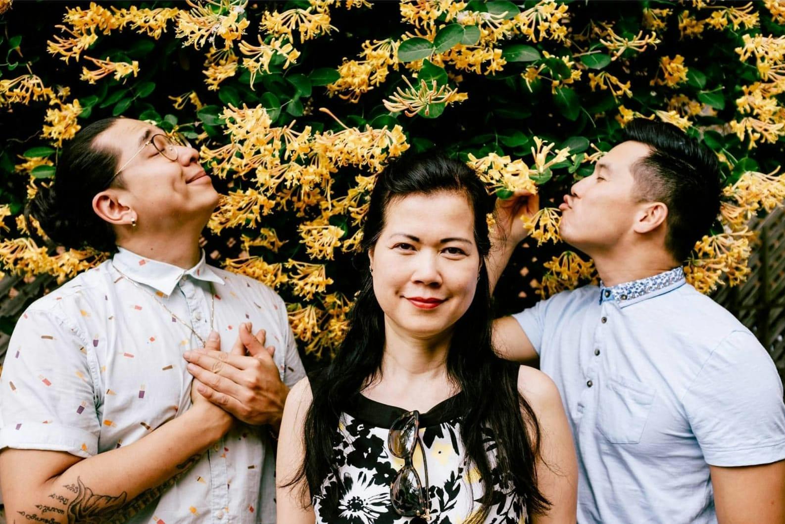 Miche, the Belle Tonkinoise and Mitch in front of a wall of yellow flowers