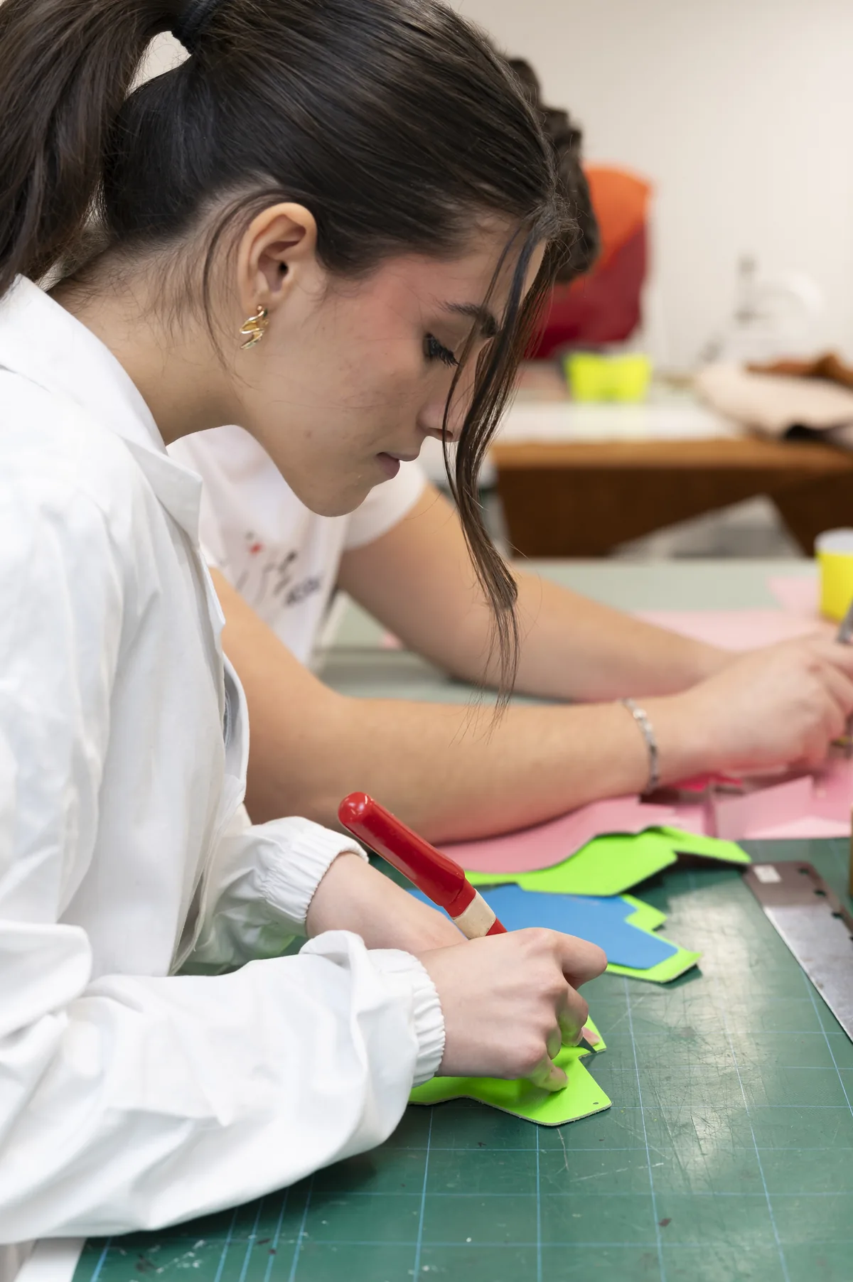 Studentessa MITA durante la lavorazione manuale di componenti in pelle