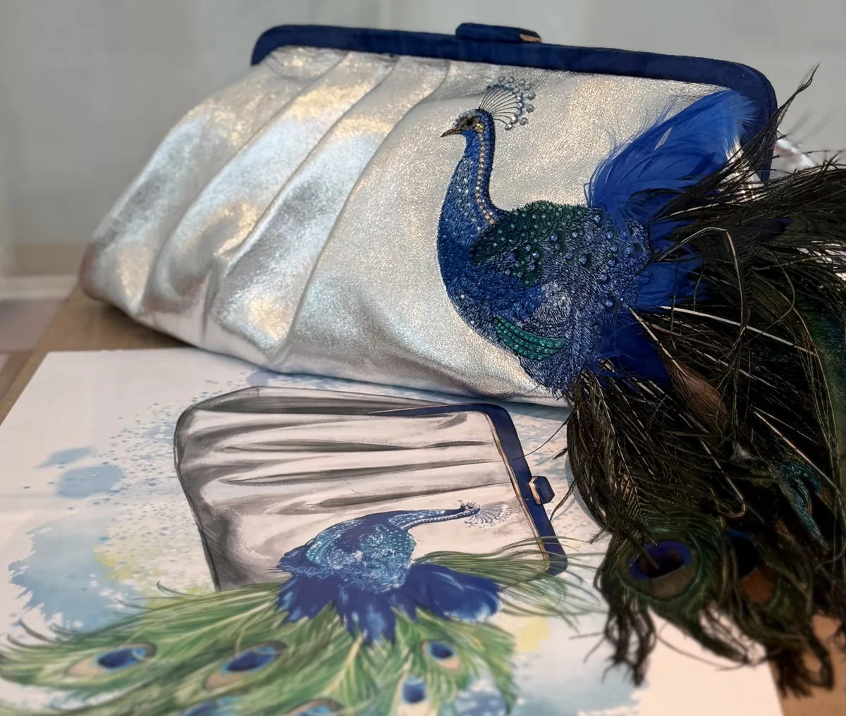 Progetto di una borsa con decorazione a pavone e riferimenti illustrati