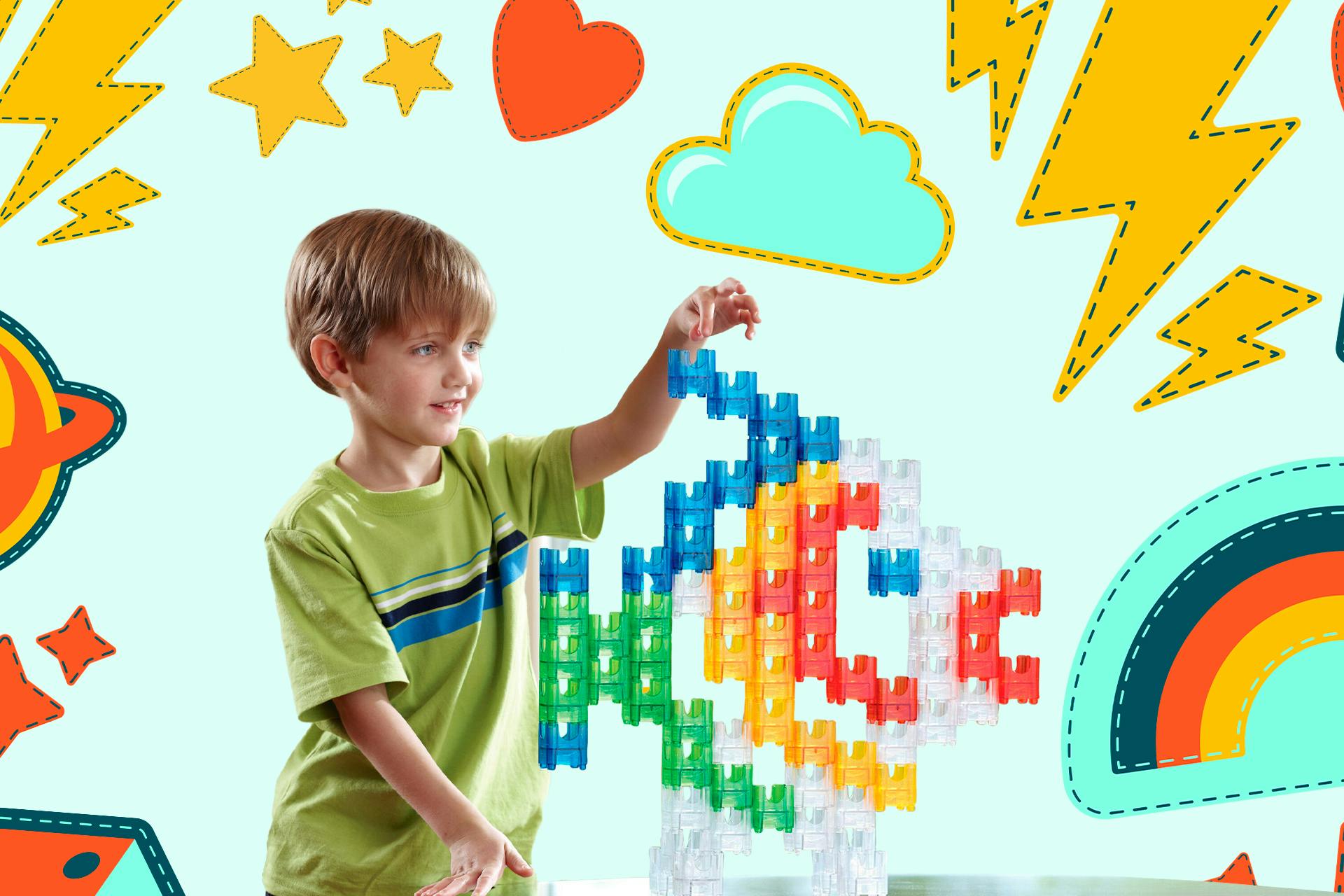Boy kid playing with colorful building blocks