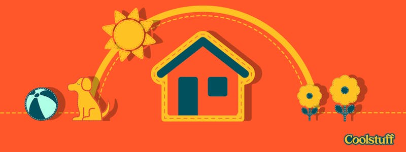 Rotes Sommerhaus, umgeben von Sommerblumen und einem Hund, der mit Ball spielt