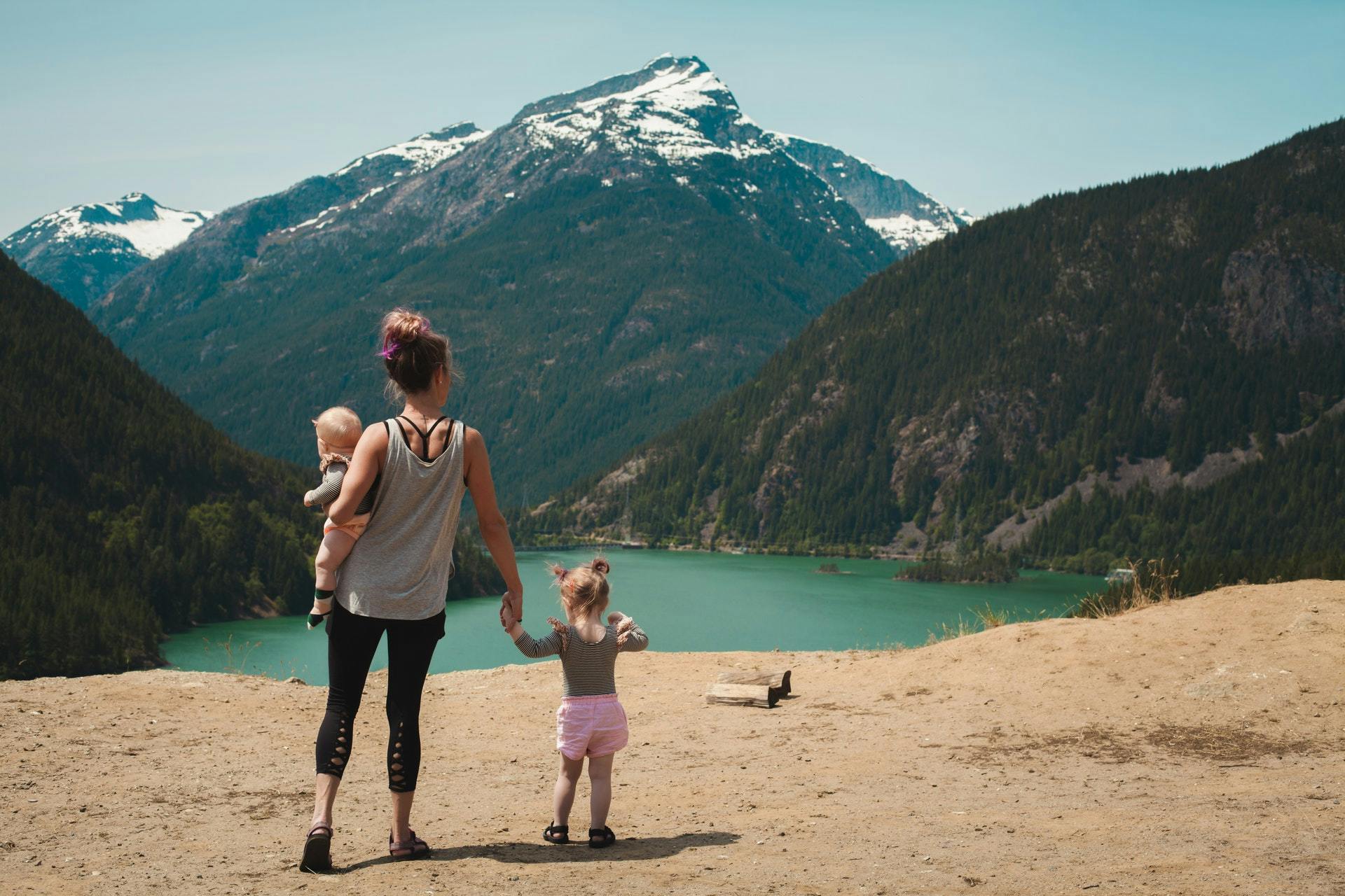 Mutter und ihre Kinder blicken auf die Berge
