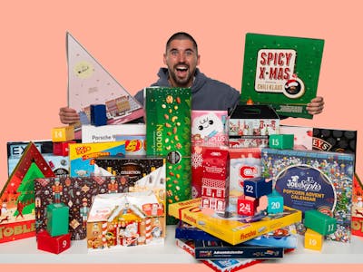 Happy man showing xmas calendars