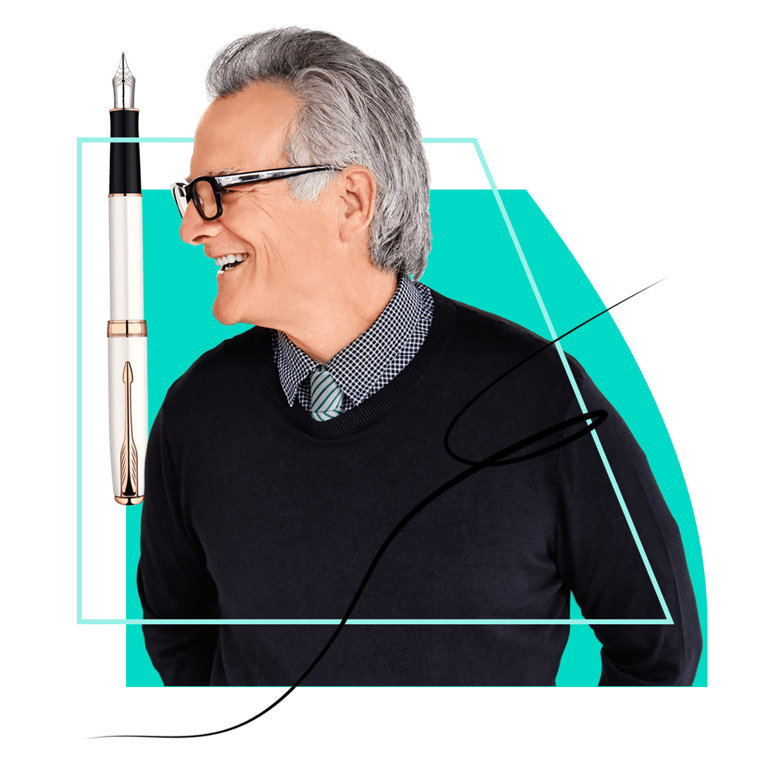 Man in glasses wearing a shirt and jumper looking at a pen